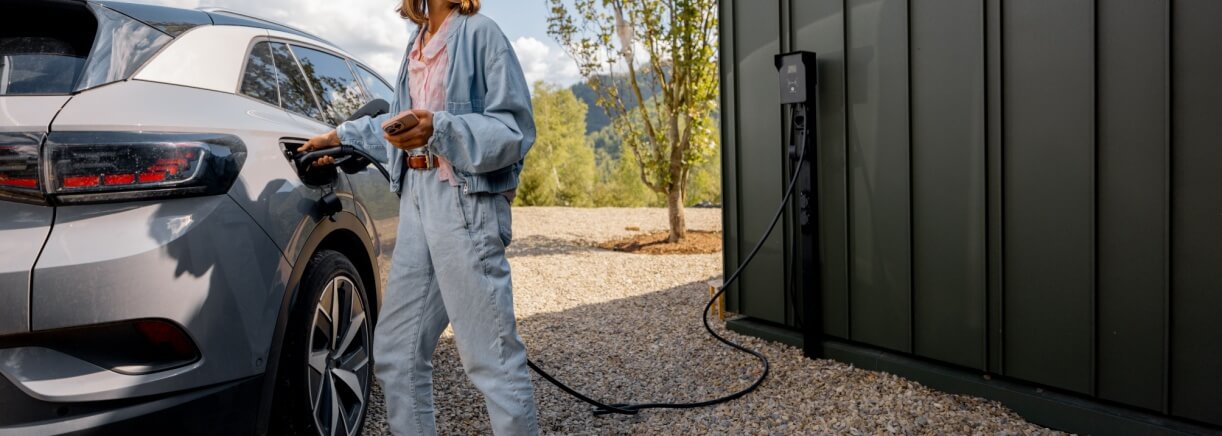 Woman charging her EV