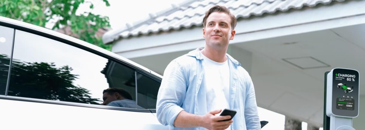 Man charging his electric vehicle at home